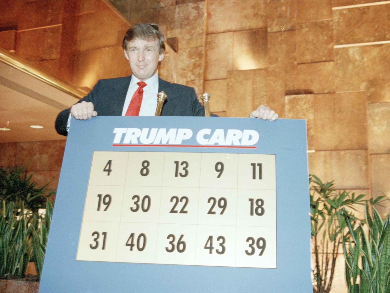 Donald Trump unveils a facsimile of the cards to be used on his proposed TV game show "Trump Card," at Trump Tower in New York, on Sept. 19, 1989.
