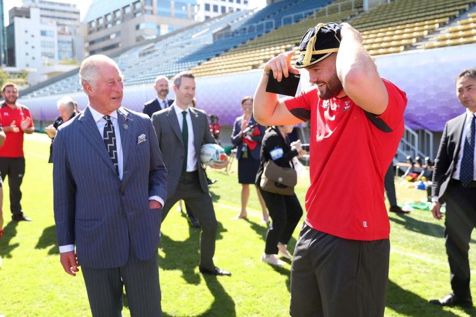 Prince Charles presents Owen Lane with his World Cup Cap during a visit to the Welsh Rugby World Cup training camp in Tokyo (AP)
