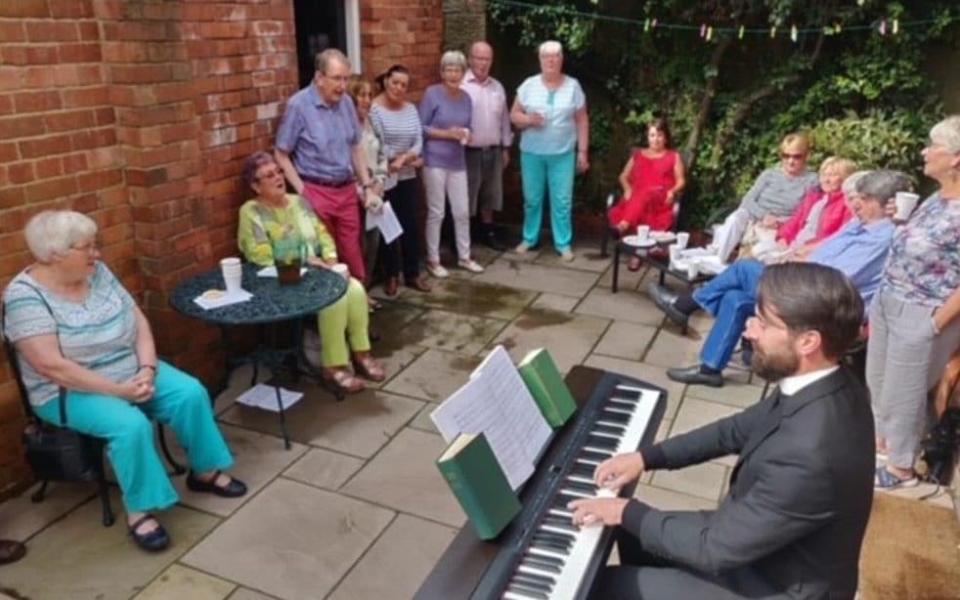 Father Lee Taylor, 43, from Llangollen, in north Wales performing for his congregation before the pandemic - PA