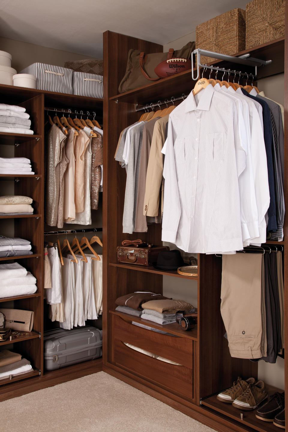 closet with open storage, hanging sections, drawers and shelves, dark wood, baskets and boxes on top shelf