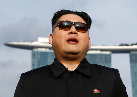 Howard, an Australian-Chinese impersonating North Korean leader Kim Jong Un, speaks with the Marina Bay Sands hotel in the background in Singapore May 27, 2018. REUTERS/Edgar Su