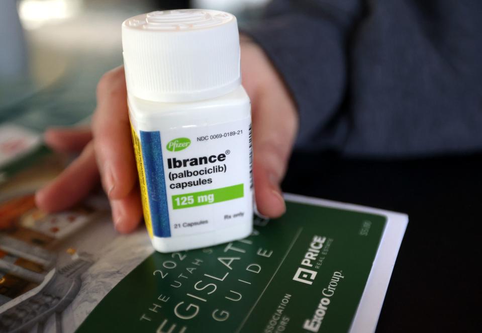 Carrie Ann Kemp holds an empty bottle of Ibrance, a medication she takes to stop her cancer from progressing, at home in Provo on Tuesday, Feb. 13, 2024. Ibrance costs $24,000 a month and there is no generic form. | Kristin Murphy, Deseret News