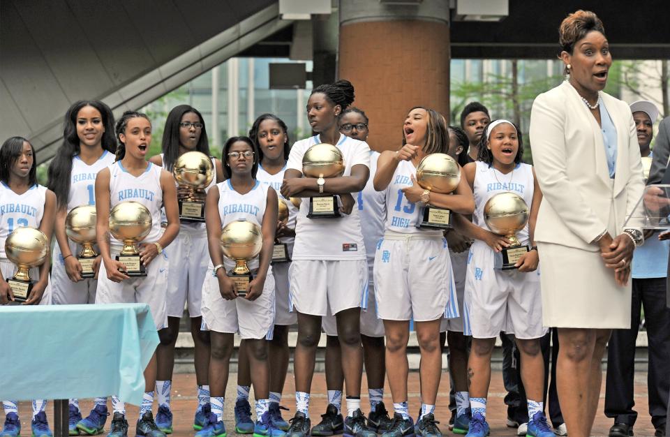 Backed by her players, Ribault head basketball coach Shelia Seymore-Pennick addresses the audience during a victory celebration and parade in Hemming Park (now James Weldon Johnson Park) on April 12, 2016.