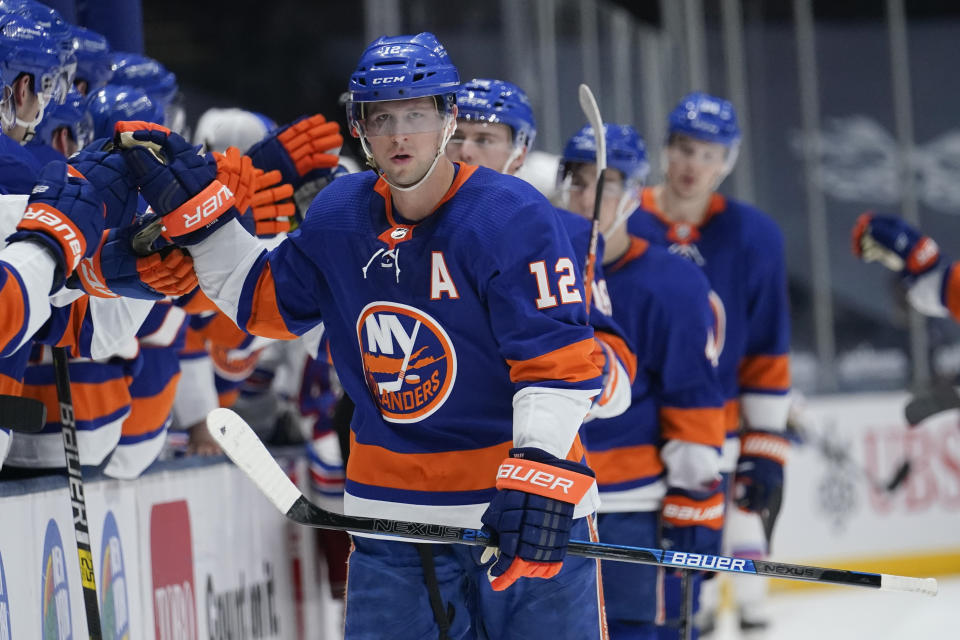 New York Islanders' Josh Bailey (12) is congratulated by teammates after his goal during the third period of the team's NHL hockey game against the New York Rangers on Tuesday, April 20, 2021, in Uniondale, N.Y. The Islanders won 6-1. (AP Photo/Frank Franklin II)