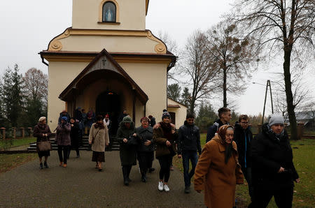 Parishioners leave the church after the mass in Kalinowka, Poland November 25, 2018. Picture taken November 25, 2018. REUTERS/Kacper Pempel/Files