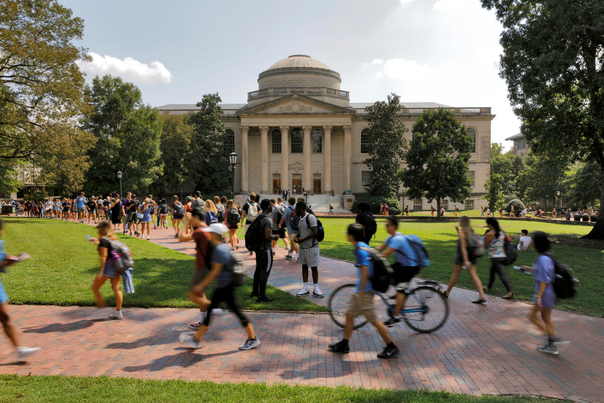 Students walk past Wilson Library at the University of North Carolina at Chapel Hill. 