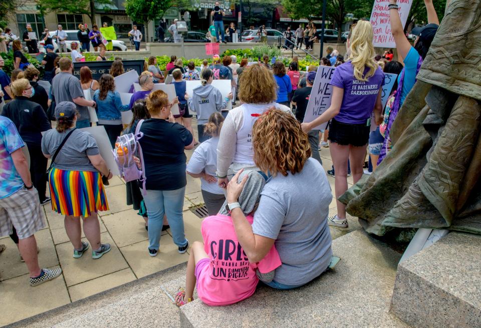 Tessa Hamilton of Peoria holds her daughter Irelynn, 7, as they take part in an abortion-rights rally Saturday, June 25, 2022, at the Soldiers and Sailors Memorial at the Peoria County Courthouse in downtown Peoria.