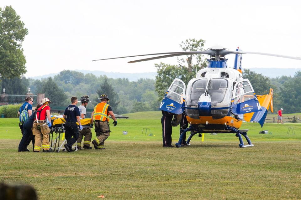 Emergency crews transport a patient to a medical helicopter at the scene where a man was heavily entrapped inside a minivan after a crash on Route 30, Friday, Aug. 2, 2024, in Berwick Township.