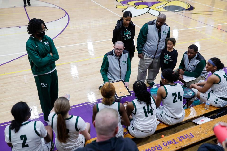 Ypsilanti Arbor Prep coach Scott Stine, center, talks to players at a timeout during the second half of Arbor Prep's 50-42 win in the MHSAA Division 3 regional semifinal at Concord High School on Tuesday, March 7, 2023.