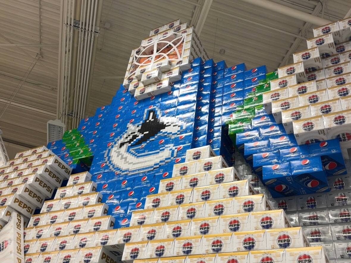 Eric Falkenberg used thousands of boxes of soda to make his Canucks display at a Save-on-Foods store in Kelowna, B.C. (Brady Strachan/CBC - image credit)