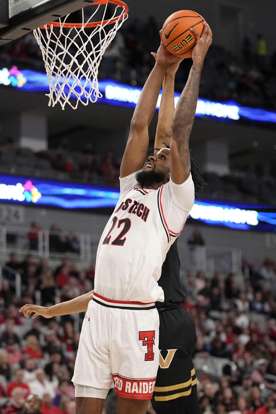 Texas Tech forward Warren Washington (22) is fouled taking a shot by Vanderbilt guard Evan Taylor, back, in the first half of an NCAA college basketball game in Fort Worth, Texas, Saturday, Dec. 16, 2023. (AP Photo/Tony Gutierrez)