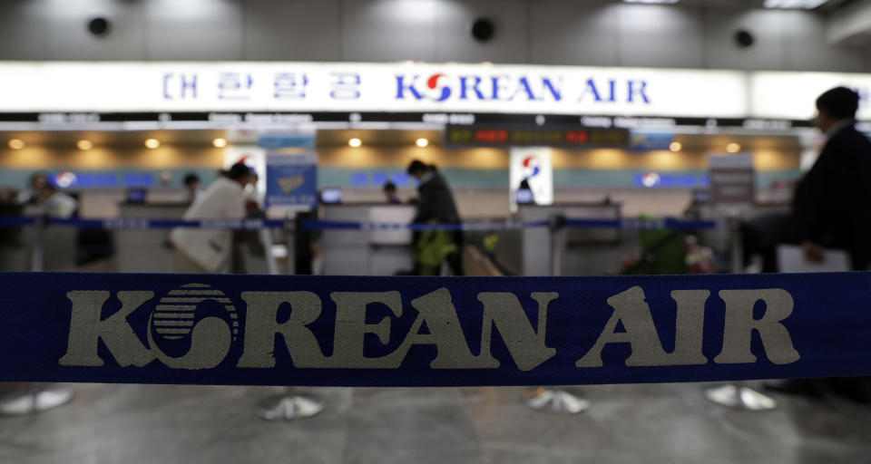 Passengers buy tickets at a Korean Air ticketing counter at Gimpo airport in Seoul, South Korea, Thursday, Oct. 25, 2012. South Korea's flagship carrier Korean Air returned to profit after two straight quarters of losses as increased international passengers and a favorable exchange rate offset lower cargo shipments. (AP Photo/Lee Jin-man)