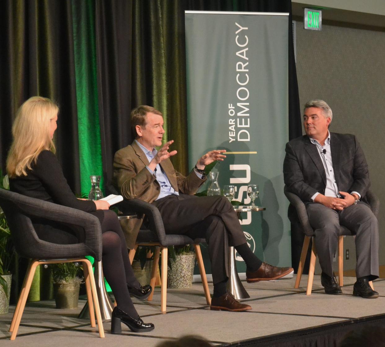 Current and former U.S. senators from Colorado, Michael Bennet, center, and Cory Gardner, right, respectively, speak at a forum moderated by Colorado State University President Amy Parsons titled "Building Bridges: Bipartisan Perspectives on Democracy" on Monday at the Lory Student Center in Fort Collins.