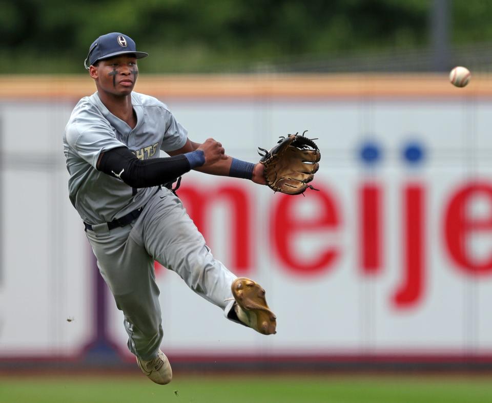 Hoban shortstop Shawn Parnell makes a leaping throw to force out Bloom-Carroll batter Mike Malone at first during the third inning of the OHSAA Division II state championship game at Canal Park on Sunday, June 13, 2021, in Akron, Ohio.