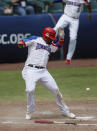 Dominican Republic catcher Charlie Valerio arrives safe at home plate after he scored a run against Venezuela during a final Olympic baseball qualifier game, in Puebla, Mexico, Saturday, June 26, 2021. (AP Photo/Fernando Llano)