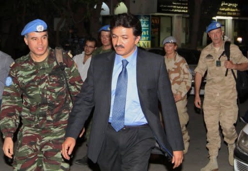 Moroccan advance team leader Colonel Ahmed Himmiche (L) and Niraj Singh (C), spokesman to the UN monitors team, tasked with monitoring the UN-backed ceasefire in Syria, arrive in Sheraton hotel in Damascus, on April 23, after visiting several rebellious suburbs near the capital. Nearly 60 people were reported killed in violence across Syria on Monday