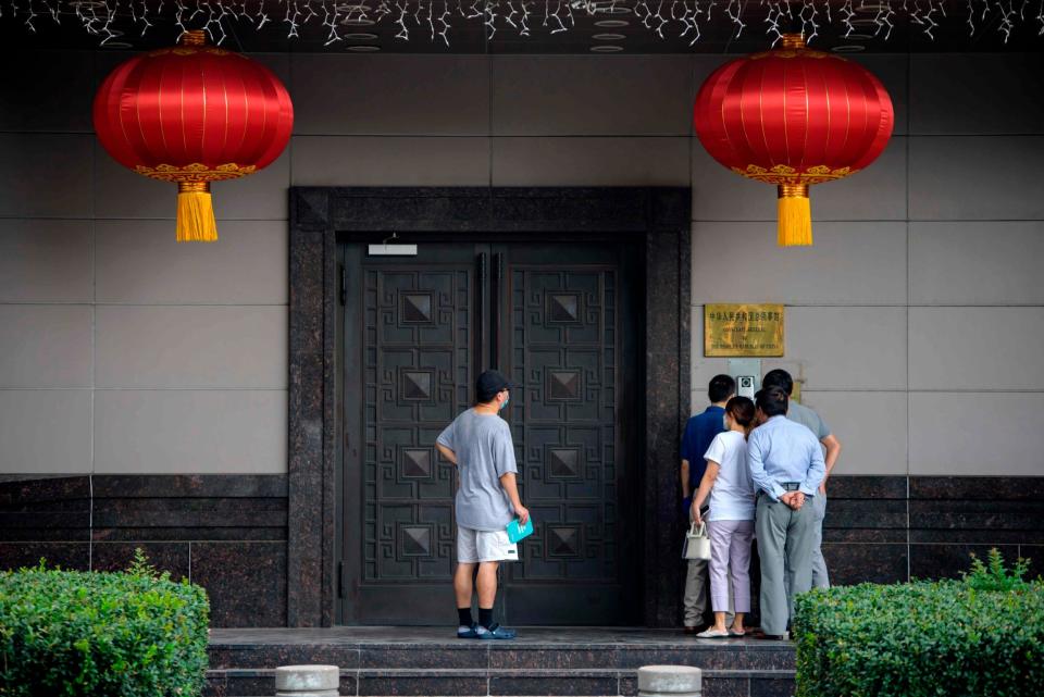 People attempt to talk to someone at the Chinese consulate in Houston on July 22, 2020 (AFP /AFP via Getty Images)