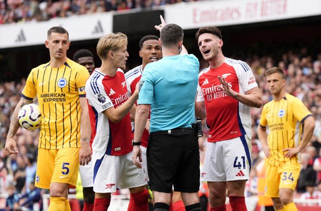 Arsenal's Declan Rice, right, pleads his innocence to referee Chris Kavanagh after being sent off against Brighton