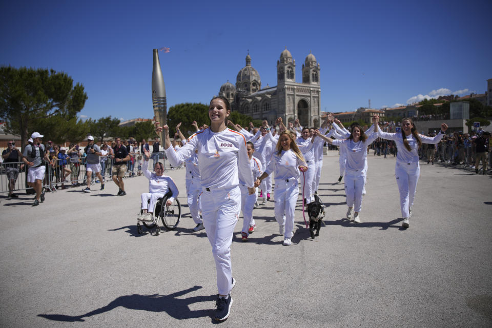 Maria Vysotchanska of Ukraine participates in the Olympic torch relay in Marseille, southern France, Thursday, May 9, 2024. Torchbearers are to carry the Olympic flame through the streets of France' s southern port city of Marseille, one day after it arrived on a majestic three-mast ship for the welcoming ceremony. (AP Photo/Daniel Cole)