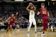 Indiana Pacers center Myles Turner (33) shoots between Cleveland Cavaliers defenders Isaac Okoro (35) and Dean Wade (32) during the second half of an NBA basketball game in Indianapolis, Sunday, Feb. 5, 2023. The Cavaliers won 122-103.(AP Photo/AJ Mast)