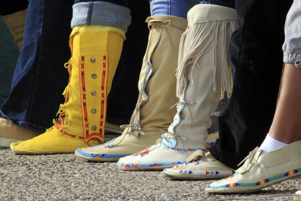 Participants display their moccasins during the "Rock Your Mocs" celebration at the Indian Pueblo Cultural Center in Albuquerque, N.M., on Friday, Nov. 15, 2013. The social media campaign started by Laguna Pueblo's Jessica "Jaylyn" Atsye has gone global with Native American and indigenous people from as far away as New Zealand participating. (AP Photo/Susan Montoya Bryan)