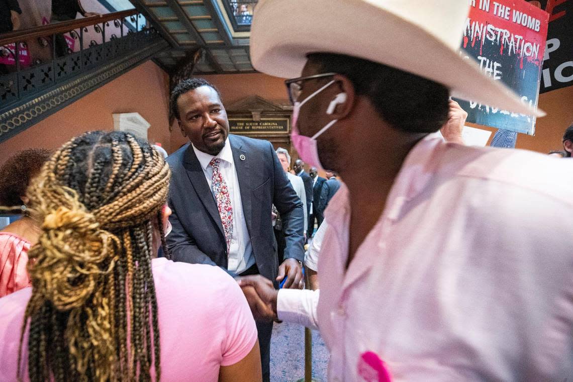 Representative Jermaine Johnson, D-Richland, speaks with protestors demonstrating for abortion access in the South Carolina State House lobby on Tuesday, June 28, 2022.