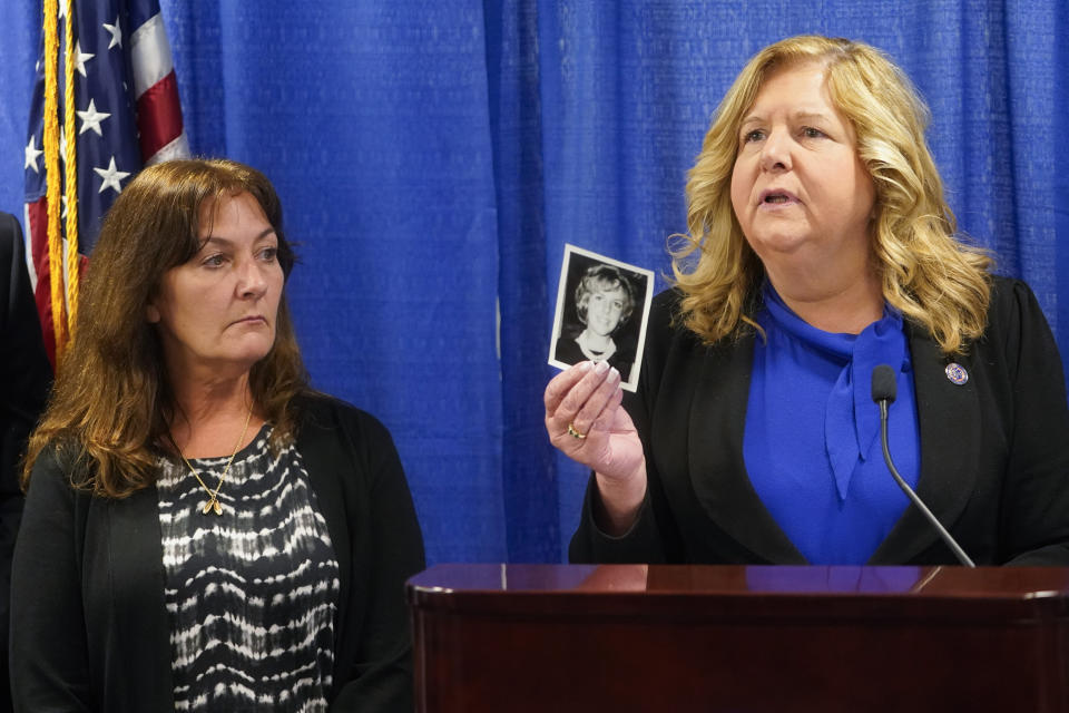 Darlene Altman, left, looks on as Nassau County District Attorney Anne Donnelly, right, holds a photo of her mother Diane Cusick during a news conference, Wednesday, June 22, 2022, in Mineola, N.Y. (AP Photo/Mary Altaffer)