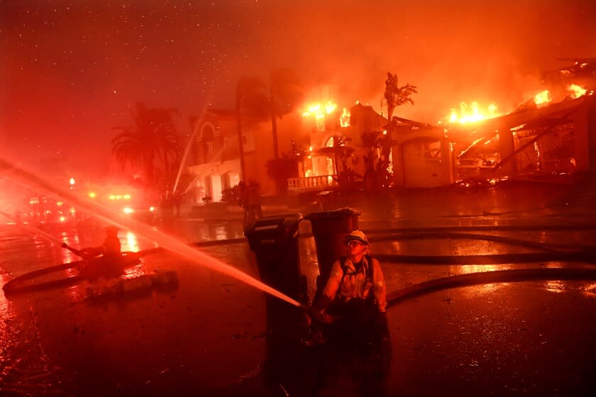 Laguna Niguel, California May 11, 2022- Firefighters battle a brush fire at Coronado Pointe in Laguna Niguel Wednesday. (Wally Skalij/Los Angeles Times)