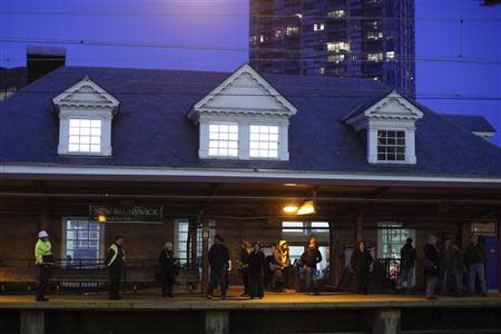 People wait at the New Brunswick station in New Brunswick, New Jersey, March 25, 2014. REUTERS/Eduardo Munoz