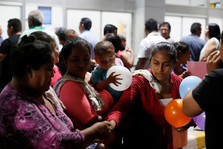 Relatives of Arnovis Guido prepare to receive Maybelline Guido at the Mons. Oscar Arnulfo Romero International Airport in San Luis Talpa, El Salvador, June 28, 2018. REUTERS/Jose Cabezas