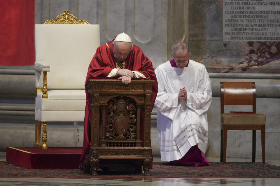 Pope Francis kneels during a Mass for the Passion of Christ, at St. Peter's Basilica, at the Vatican, Friday, April 10, 2020. The new coronavirus causes mild or moderate symptoms for most people, but for some, especially older adults and people with existing health problems, it can cause more severe illness or death. (AP Photo/Andrew Medichini, Pool)