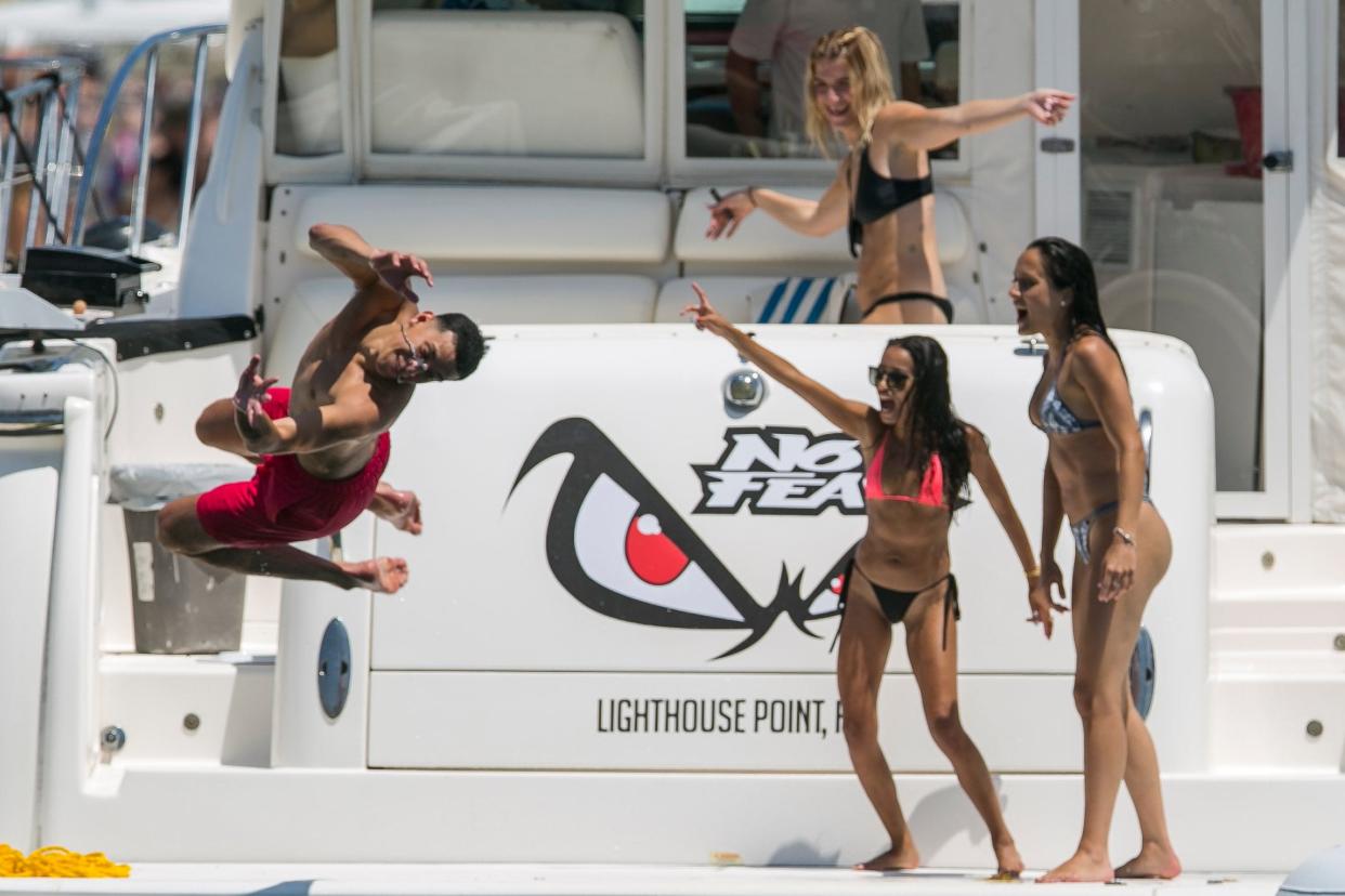 A man jumps into the water at the Boca Bash on Lake Boca Raton on April 28, 2019 in Boca Raton, Florida