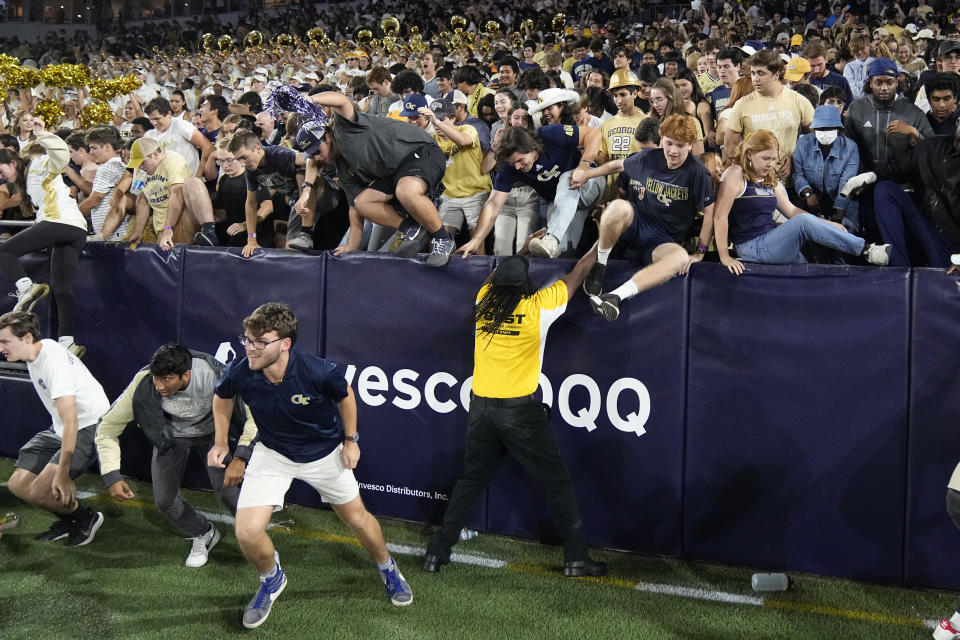 Georgia Tech fans rush the field after the Yellow Jackets defeated North Carolina in an NCAA college football game, Saturday, Oct. 28, 2023, in Atlanta. (AP Photo/John Bzemore)