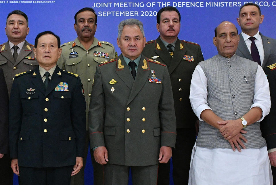 FILE - In this file photo taken Friday, Sept. 4, 2020, China's Minister of National Defence Wei Fenghe, left, Russian Defense Minister Sergei Shoigu, center, and Indian Defense Minister, Rajnath Singh, right, pose for a photo with their colleagues at a Joint Meeting of Defense Ministers of Shanghai Cooperation Organisation, Commonwealth of Independent States and Collective Security Treaty Organization Member States in Moscow, Russia. India and China are accusing each other of violating agreements along their disputed mountain border, even as they engage in talks to end increasing military tensions. (Host Photo Agency sco-russia2020.ru via AP, File) ///