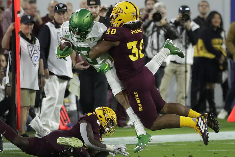 Oregon wide receiver Johnny Johnson III (3) is hit by Arizona State linebacker Elijah Juarez (30) during the first half of an NCAA college football game Saturday, Nov. 23, 2019, in Tempe, Ariz. (AP Photo/Matt York)