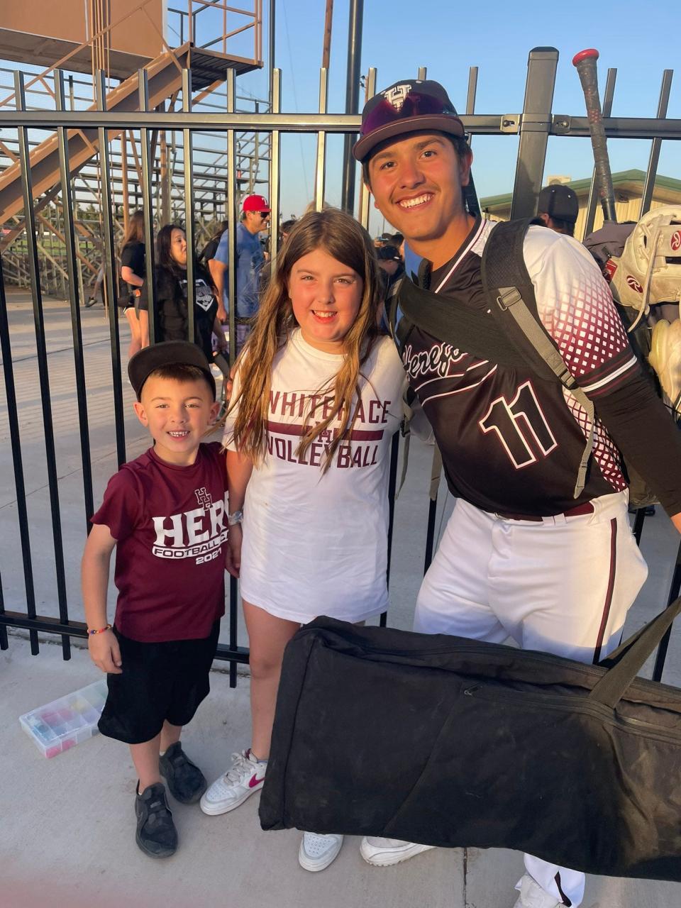 Hereford's Carlos Duran poses with two young fans after a game.