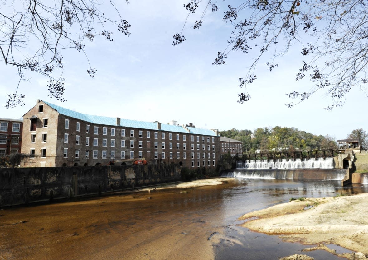 A once-abandoned cotton gin factory that is being renovated into apartments stands beside Autauga Creek in Prattville, Ala., on Thursday, Nov. 10, 2022. The factory’s history is tied up in slavery, and the project demonstrates the difficulty of telling complicated U.S. history. (AP Photo/Jay Reeves)