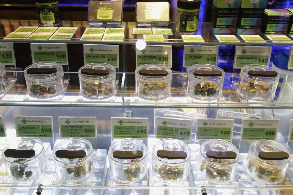 Various marijuana buds for sale are displayed at The Green Cross cannabis dispensary in San Francisco, Wednesday, March 18, 2020. As about 7 million people in the San Francisco Bay Area are under shelter-in-place orders, only allowed to leave their homes for crucial needs in an attempt to slow virus spread, marijuana stores remain open and are being considered "essential services." (AP Photo/Jeff Chiu)