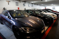 FILE PHOTO: Tesla Model 3 and X cars charging in an underground parking lot next to a Tesla store in San Diego, California, U.S., May 30, 2018. REUTERS/Mike Blake/File Photo