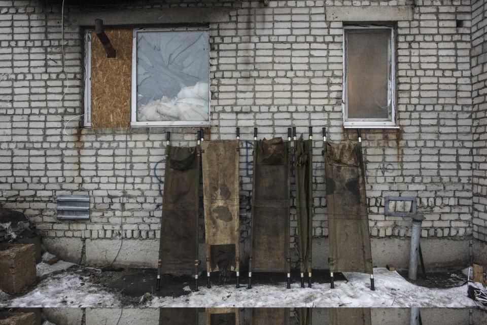 Millitary stretchers stand on the wall where Ukrainian servicemen based in Avdiivka, Ukraine, Saturday, Feb. 4, 2017. Fighting in eastern Ukraine sharply escalated this week. Ukraine's military said several soldiers were killed over the past day in shelling in eastern Ukraine, where fighting has escalated over the past week. (AP Photo/Evgeniy Maloletka)