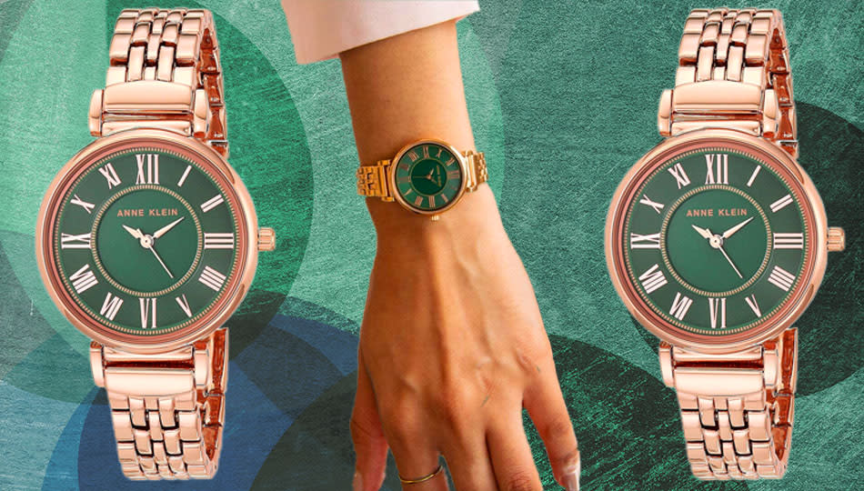 person wearing rose gold chain link watch with green face