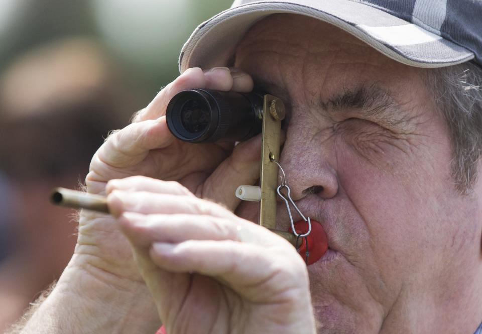 A competitor takes aim during the 2014 World Pea Shooting Championship in Witcham, southern England