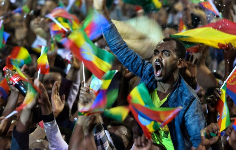 People celebrate during an event in Addis Ababa in honour of visiting Eritrean President Isaias Afwerki just days after the two countries signed a peace deal