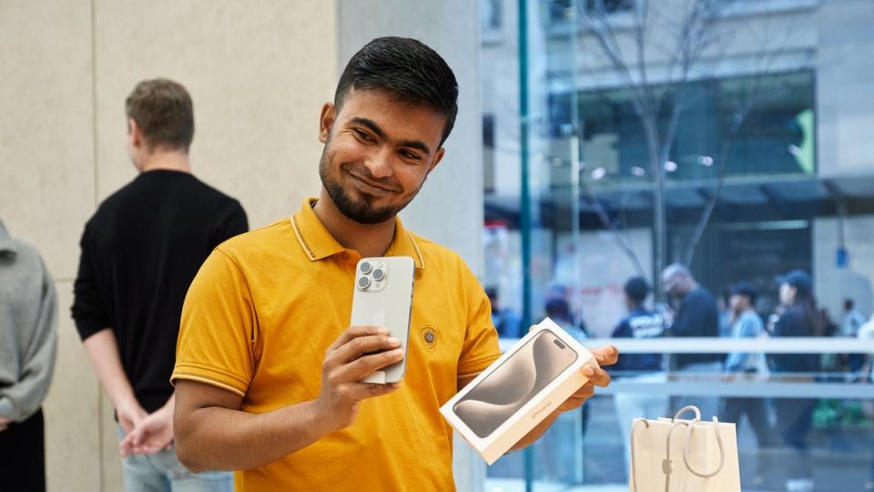 An Apple Store customer unboxes their iPhone 15 Pro (Apple)