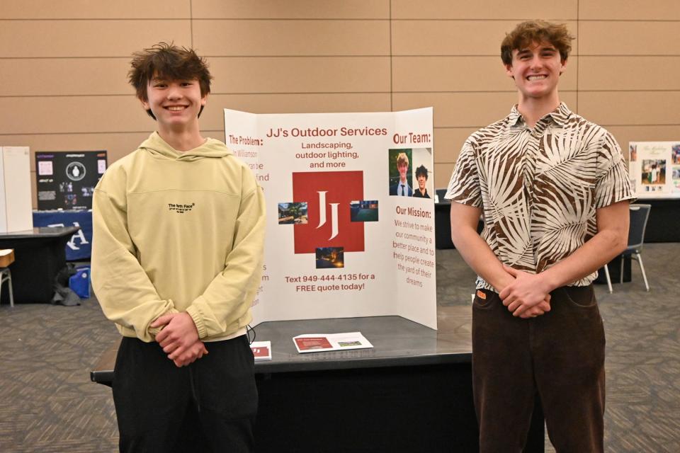 High school juniors John Lee, left, and Jacob Dykstra of Franklin High School stand with their display for JJ’s Outdoor Services during MTSU’s 2024 High School Entrepreneurship Fair held Tuesday, Feb. 20, in the Student Union Ballroom. The students were among the top five finalists.