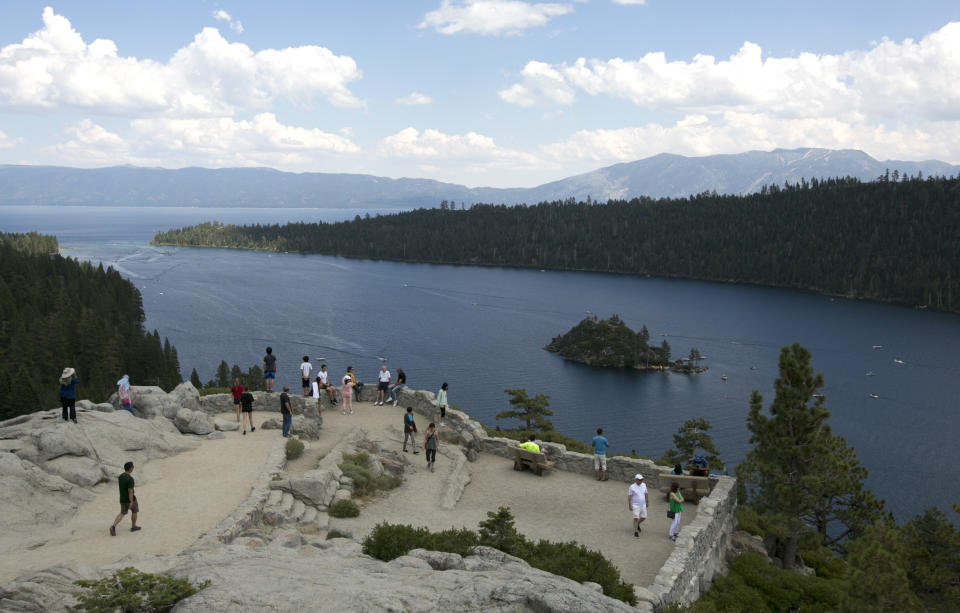 FILE - In this Aug. 8. 2017, file photo, visitors view Emerald Bay on the west shore of Lake Tahoe, near South Lake Tahoe, Calif. The fallout from humanity's addition to plastics is showing up in the waters of Lake Tahoe. Scientists detected microplastics at several locations around the lake for the first time this year and are working to understand what that means for human health and the environment of the Tahoe Basin. (AP Photo/Rich Pedroncelli, File)