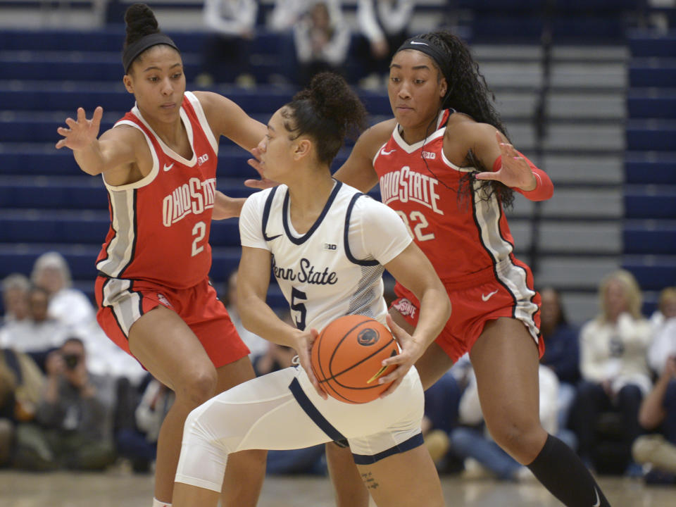 Ohio State's Taylor Thierry (2) and Cotie McMahon, right, pressure Penn State's Leilani Kapinus (5) during the first half of an NCAA college basketball game Thursday, Feb. 22, 2024, in State College, Pa. (AP Photo/Gary M. Baranec)