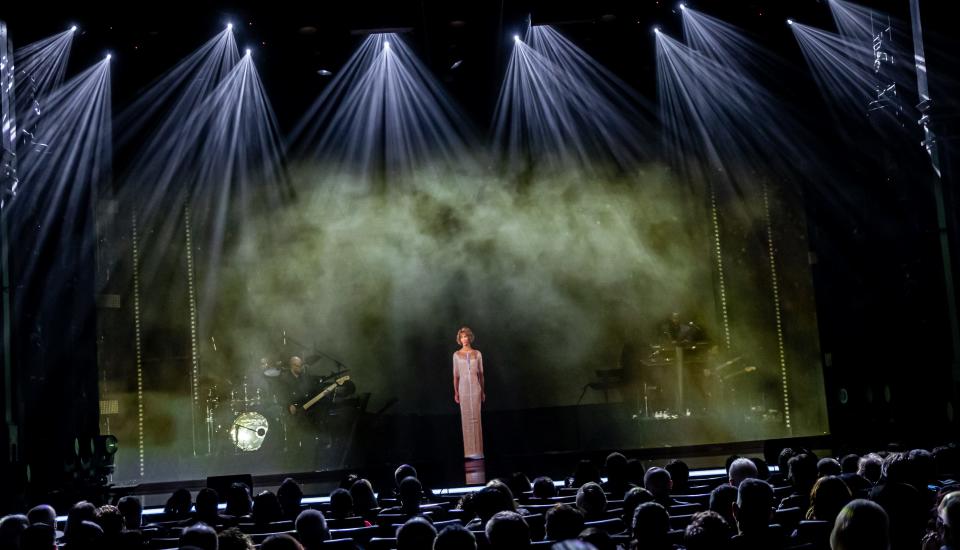 The Whitney Houston hologram concert at Harrah's Las Vegas includes a live band and dancers.