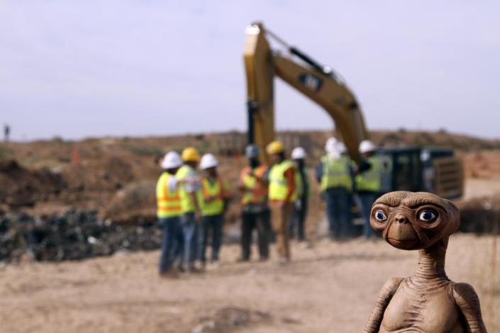 An E.T. doll is seen while construction workers prepare to dig into a landfill in Alamogordo, N.M., Saturday, April 26, 2014. Producers of a documentary are digging in the landfill in search of millions of cartridges of the Atari 'E.T. the Extra-Terrestrial' game that has been called the worst game in the history of videogaming. A New York Times article from 1983 reported that Atari cartridges of "E.T. The Extraterrestrial" were dumped in the landfill in Alamogordo. (AP Photo/Juan Carlos Llorca)