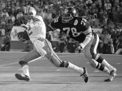 File-This Jan. 18, 1976, file photo shows Pittsburgh Steeler Dwight White (78), chasing down Dallas Cowboys quarterback Roger Staubach in the second quarter of Super Bowl X in Miami. Members of a special panel of 26 selected all of them for the position as part of the NFL's celebration of its 100th season. All won league titles except Marino. All are in the Hall of Fame except Brady and Manning, who are not yet eligible. On Friday night, quarterback was the final position revealed for the All-Time Team. (AP Photo/File)